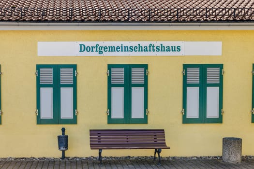 Village Community Center Sign on a yellow house facade in germany.