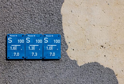 Blue metall Information sign about the stop cock of underground water pipes.