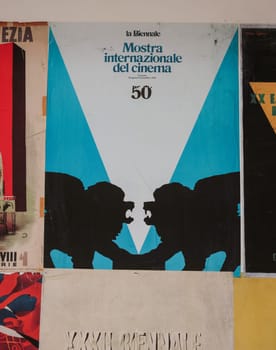 Venice, Italy - May 7, 2024:  60th Venice Art Biennale in Venice. Old posters advertising the Venice Biennale presented in the central pavilion in Giardini