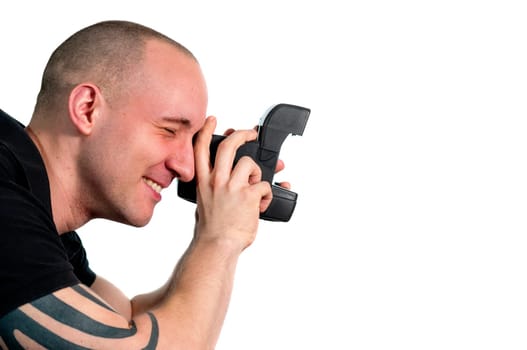 Head and shoulder portrait of a young man with instant camera in profile isolated on white.