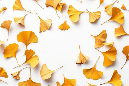 A close up of yellow leaves scattered across a white background