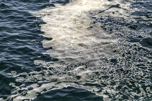 Detail of foam and dirt in sea water, environment