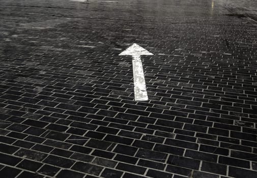 Detail of direction arrow for vehicles on a road
