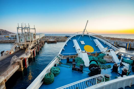 Malta to Gozo, Passengers board modern ferry at Cirkewwa Passenger terminal for scenic cruise to idyllic Gozo Island. Malta travel destination.