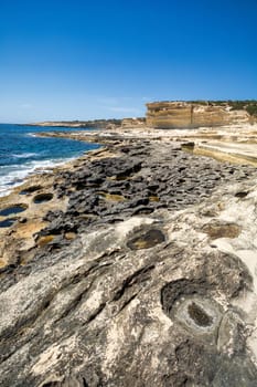 Beautiful coastal view of Delimara peninsula, with rocks and turquoise sea, near Saint Peter's Pool, Island Malta natural landscape.