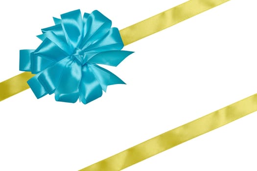Yellow silk ribbon and a tied big blue bow on an isolated background, top view. Gift packaging