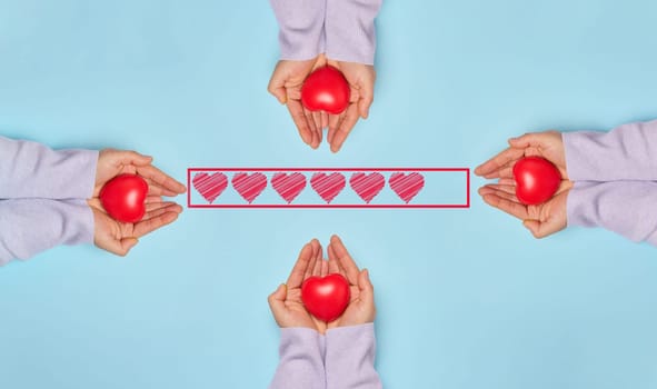 Female hands holding a red heart on a blue background, organ and blood donation concept. Replenishment of the blood bank in medical institutions