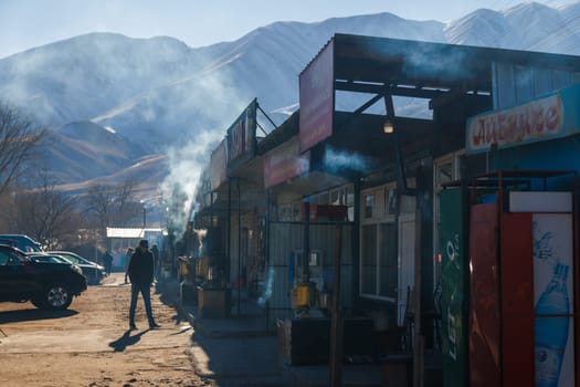 Row of Kyrgyz kattama cafe on side of the road to Issyk-Kul lake in Cholok, Kyrgyzstan at sunny day. Kattama - is a traditional Kyrgyz puff pastry.