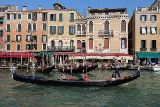 Venice, Italy - September 6, 2022: Tourists during a Gondola cruise on the Grand Canal in Venice. Italy