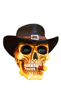 Closeup of scary human skull with vintage cowboy hat on his head and a cigar in his mouth isolated on a white background. Clipping path.
