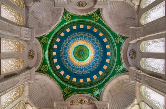 Photo of the ornate interior of Bibi-Heybat Mosque, with intricate details, vibrant colors, and beautiful patterns on the dome, Baku, Azerbaijan
