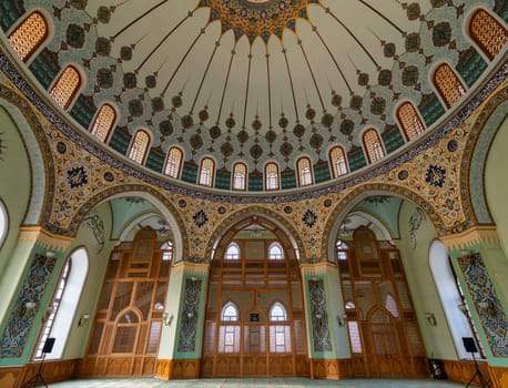 Interior of Taza Pir Mosque in Baku, Azerbaijan, admire its ornate dome and intricate architecture blending traditional Islamic motifs with modern elements