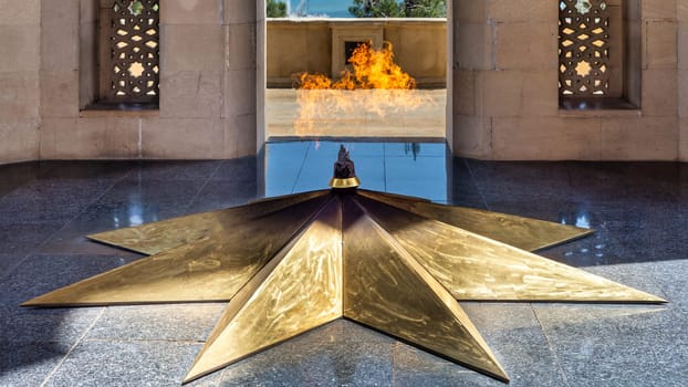 Close-up of the Eternal Flame at Shahidlar Monument in Baku, Azerbaijan, burning on a golden star, honoring those who died in the war