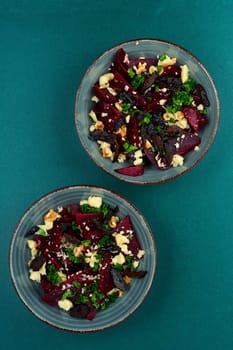 Diet salad of beets, nuts and cheese on the plate. Flat lay.