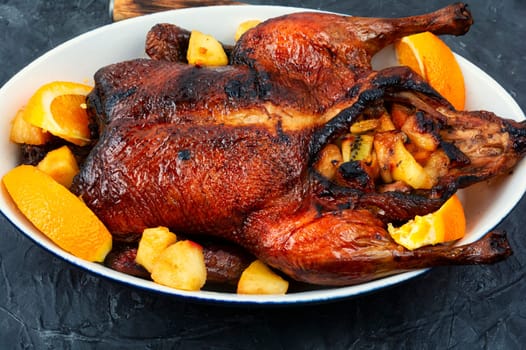 Appetizing duck baked with oranges and caramelized apples.