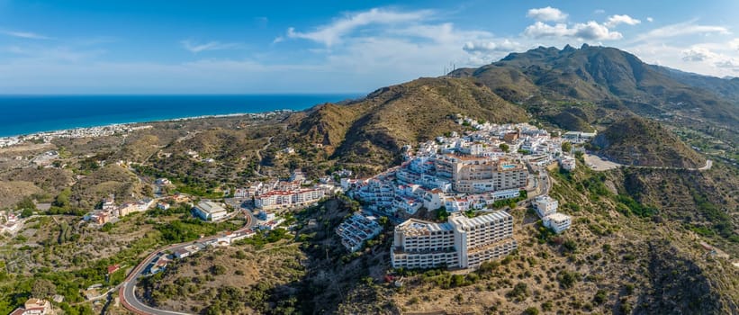 Picturesque spanish hillside white washed village of Mojacar during sunny day against blue sky. Travel destinations, famous places. Europe, southern Spain great panoramic view