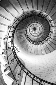 Plouguerneau, France - August, 08 2017 : Black and white vertical real photography of Spiral stairs inside the lighthouse, brittany,france