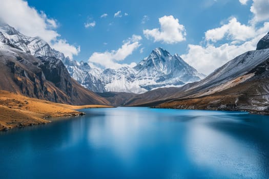 Tranquil blue lake surrounded by snow-capped mountains