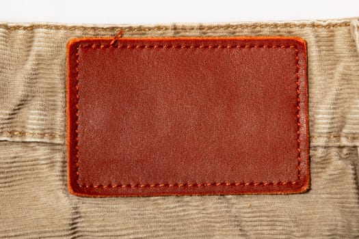leather patch on beige corduroy trousers