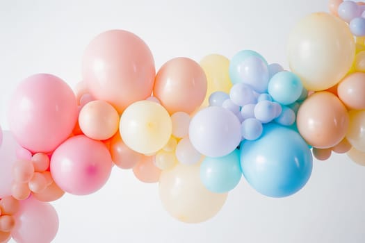 Cluster of pastel-colored balloons in various shapes and sizes, perfect for birthday parties
