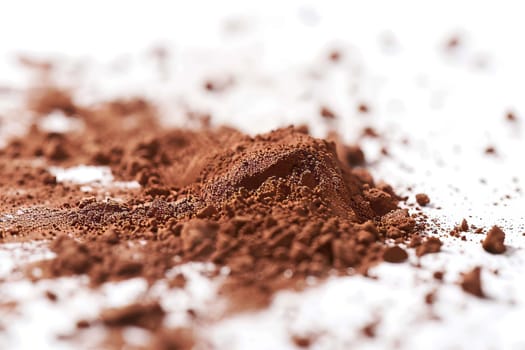 Cocoa powder dust against a soft transparent white surface, adding richness to designs