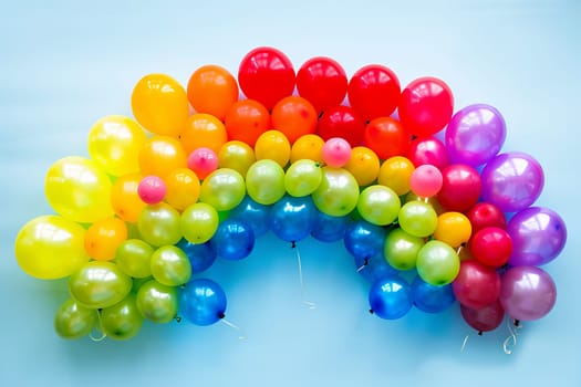 Colorful balloons arranged in the shape of a rainbow, symbolizing hope and positivity