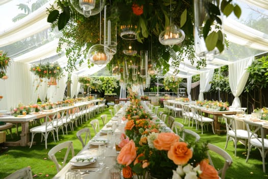 A large outdoor wedding reception with a long table covered in flowers and candles. The tables are set with white tablecloths and white chairs