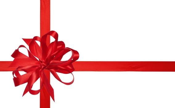 Red silk ribbon and a tied big bow on an isolated background, top view