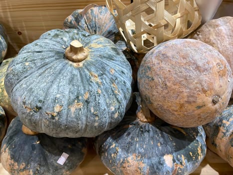 Lots of pumpkins on a market stall.