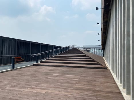 A wooden walkway winds its way towards a building.