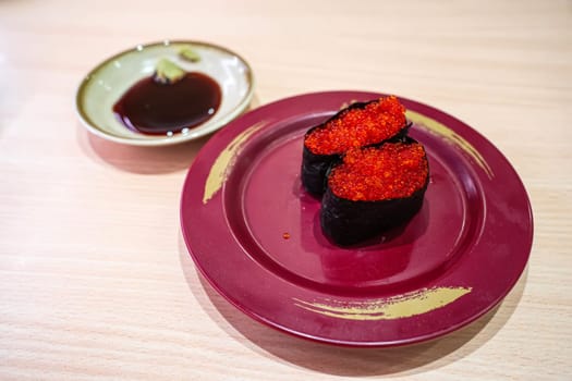 Fish egg sushi in the plate. Sushi is a type of food preparation originating in Japan.