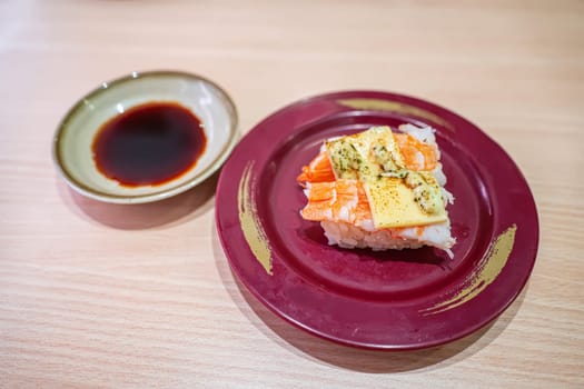 Grilled shrimp sushi with cheese and basil sauce in the plate. Sushi is a type of food preparation originating in Japan.