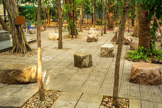 A large stone made into a chair to decorate the garden.