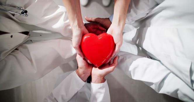 Medical Health Insurance Concept. Group Of Doctors Holding Heart