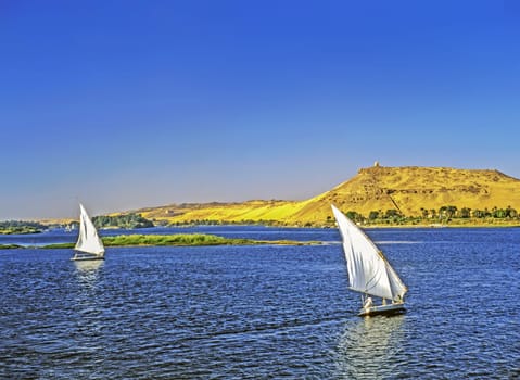 Feluccas on River Nile in background monument  to  Aga Khan