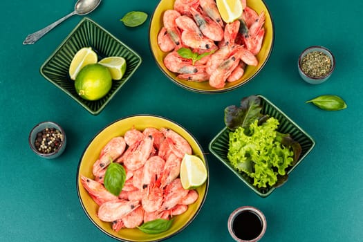 Raw unpeeled prawns or shrimps with an assortment of cooking spices.