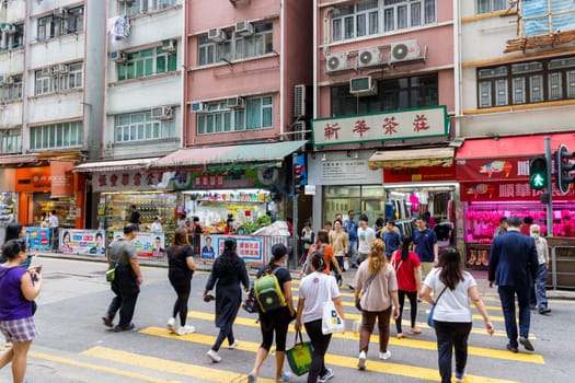 Hong Kong 24 April 2024: People cross the road in Hong Kong city in Sheung wan district