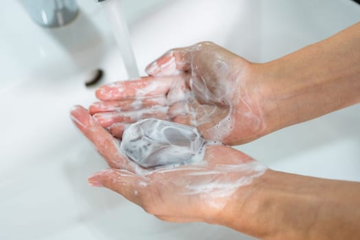 Use soap and washing hands under the water tap