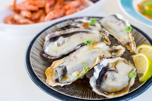 Tasty fresh raw oyster on the plate in restaurant
