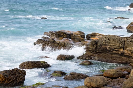 Sea ocean wave over the rocky stone