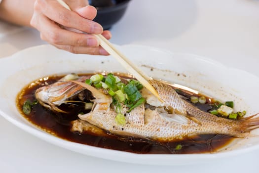 Steamed fish with soy sauce on the dish