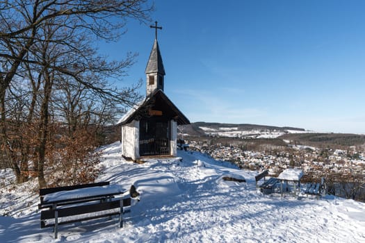 Kreuzau, Germany - January 20, 2024: Small chapel in the Eifel mountains with view to Obermaubach during winter on January 20 2024 in Nord Rhine Westphalia Germany