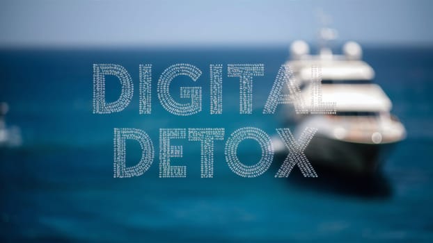 The Digital Detox phrase with ocean views and a blurred yacht in the background, promoting the idea of taking a break from digital devices to enjoy nature.