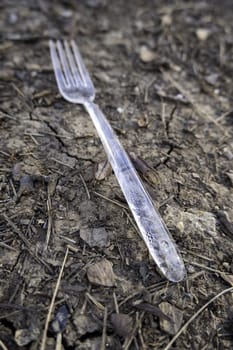 Detail of plastic fork thrown in nature, pollution