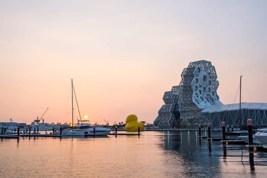 Taiwan, 31 January 2024: Kaohsiung Music Center with rubber duck under sunset