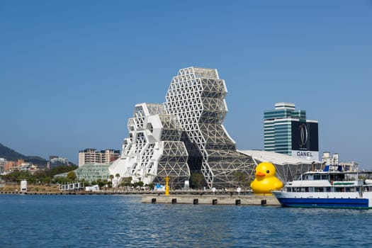Taiwan, 01 February 2024: Kaohsiung Music Center with yellow duck floating over the bay