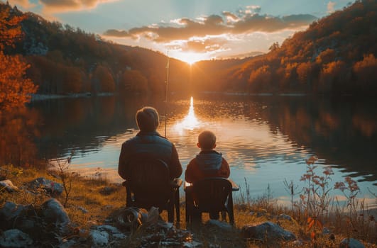 A couple, possibly a father and son, are seated on a rustic bench by the tranquil waters of a lake. They appear to be engaged in a moment of contemplation and relaxation, enjoying the peaceful surroundings.