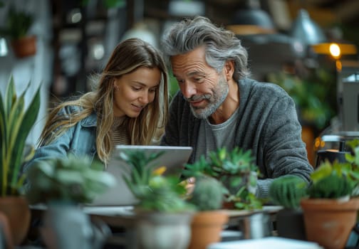 A couple in love, a man and a woman, are working together on their laptops, surrounded by lush greenery in a tranquil setting. They are intently focused on their devices, their faces illuminated by the screens glow. The warmth of their connection is palpable, even as they navigate the digital world.