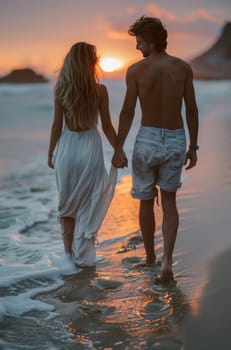 A man and a woman walk hand in hand along the sandy beach, silhouetted against the radiant colors of the setting sun, with gentle waves lapping at their feet.
