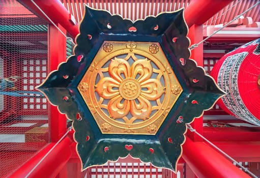 tokyo, asakusa - may 17 2024: Golden arabesque of hexagonal shape representing floral motifs under a giant copper lantern suspended under the houzoumon called also nyomon gate of the sensoji temple.